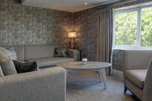 a living room with a couch and a table at The Lord Street Hotel; BW Signature Collection in Southport