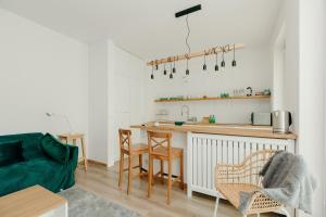 a living room with a kitchen with a counter at ShortStayPoland Marymoncka in Warsaw