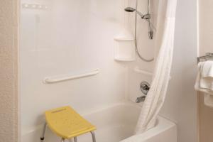 a white bath tub sitting next to a white toilet at Clarion Pointe Beckley in Beckley