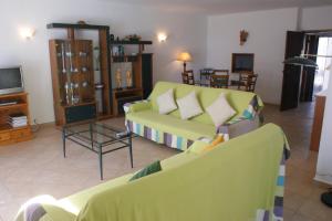 a living room with two couches and a tv at Villa Da Colina - front line villa over looking the beach and golf course in Vale Do Lobo in Vale do Lobo