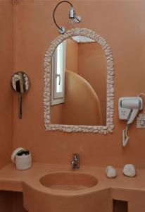 a bathroom with a sink and a mirror at Luxury Paros Villa 2 Bedrooms Villa Royalty Beautiful Sea Views & Private Terrace Naousa in Kampos Paros