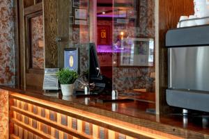 a reception desk with a phone and a computer at The Lord Street Hotel; BW Signature Collection in Southport