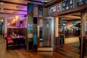 a dining room with a table and a bar at The Lord Street Hotel; BW Signature Collection in Southport