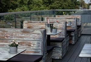 a row of wooden crates with plants on a deck at The Lord Street Hotel; BW Signature Collection in Southport