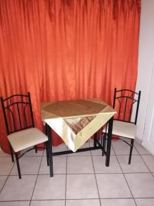 a table and two chairs with a tablecloth on it at Guesthaven B&B in Middelburg