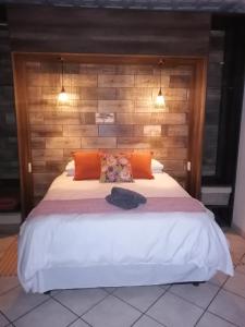 a bedroom with a large bed with a wooden headboard at Guesthaven B&B in Middelburg
