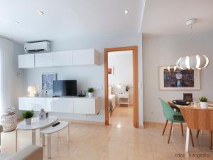 a living room with a table and a dining room at Encantador apartamento junto al Mediterraneo by Hometels in Puerto de Sagunto