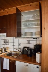 a kitchen with a sink and a counter top at Puruvesi Holiday Villas, Kalliohovi in Hiukkajoki