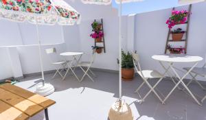 a room with two tables and chairs and flowers at Lalitana Townhouse in Lagos
