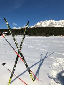 a pair of skis sitting in the snow at Landhaus Lührmann in Ramsau am Dachstein
