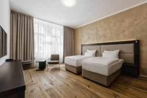 Postel nebo postele na pokoji v ubytování Theresian Hotel