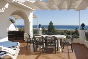 a patio with a table and chairs and the ocean at Sisos Place in Zahara de los Atunes