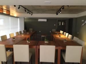 a conference room with a long wooden table and chairs at Hotel do Mar Cabo Branco in João Pessoa +30 photos