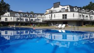 a large swimming pool in front of a building at Apartament Orange Sun nr°7 in Pobierowo