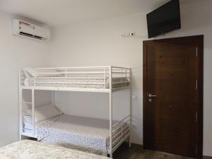 a room with two bunk beds and a television at Lo Trabucador Casa nueva en el corazón del Delta in Poblenou del Delta