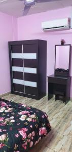 a bedroom with a bed and a dresser and a mirror at Serene Homes in Banting