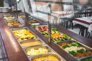a buffet line with many different types of food at Hôtel Estival Arriel entièrement climatisé in Lourdes +11 photos
