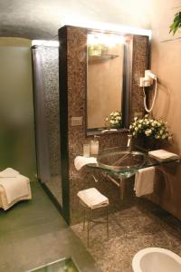 a bathroom with a sink and a mirror at Locanda Tramonti in La Spezia