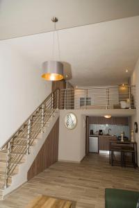 a living room with a staircase and a kitchen at YourCastle2 in Alexandroupoli