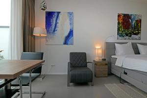 a bedroom with a bed and a desk and a chair at Black Jack Suites Amsterdam in Amsterdam