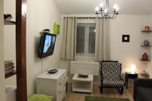 a living room with a tv and a chair at PrivOffice4U Samurai - Old Town, Main Square, Main station in Krakow