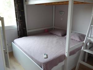 a small bedroom with a bunk bed and a ladder at Villa T6, 10 couchages, front de mer, piscine, Saint Pierre la Mer in Saint Pierre La Mer
