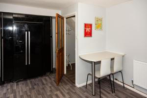 a kitchen with a black refrigerator and a table at Backworth - Alexander Apartments in Backworth