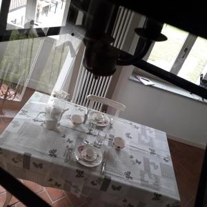 a table with a white table cloth on it at Cascina Spazio Indaco in Castagnole Monferrato