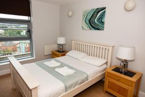 a bedroom with a bed and a lamp at Alexander Quayside in Newcastle upon Tyne