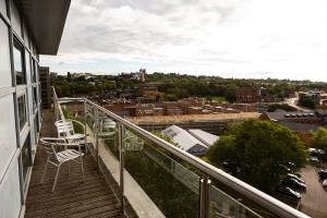 a balcony overlooking a city with a view of the ocean at Alexander Quayside in Newcastle upon Tyne