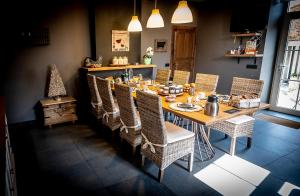 a dining room with a wooden table and chairs at La Belle Étable in Dinant