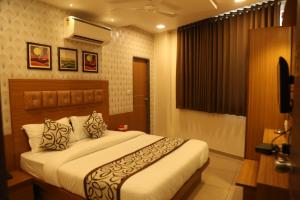a bedroom with a large bed in a room at HOTEL RK PALACE in Ahmedabad