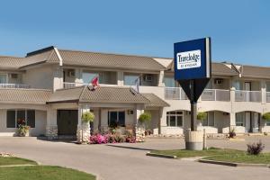 a hotel sign in front of a building at Travelodge by Wyndham Edson in Edson