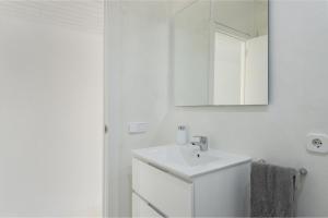 a white bathroom with a sink and a mirror at Sa Nacra in Alcudia +19 photos