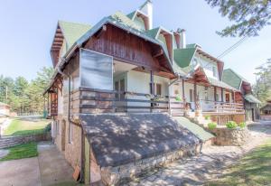 a house with a large window on the front of it at Apartman Sanja Divčibare in Divčibare