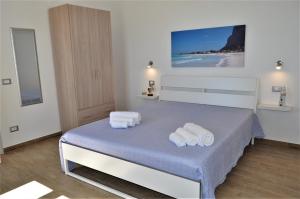 Posteľ alebo postele v izbe v ubytovaní Casa Vacanze Monte Cofano
