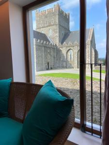 a room with a couch and a window with a castle at The Rooms At Firecastle in Kildare