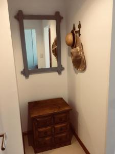 a bathroom with a wooden dresser and a mirror at A la meseta in Puerto Madryn