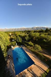 an overhead view of a large blue swimming pool at Yerba Buena casas de campo - Nono in Nono