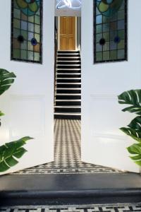 un couloir avec deux portes et un escalier dans l'établissement CG Kensington, à Londres