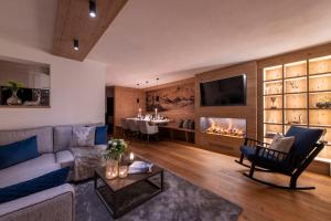 a living room with a couch and a fireplace at Brunnenhof Luxury Apartments in Lech am Arlberg
