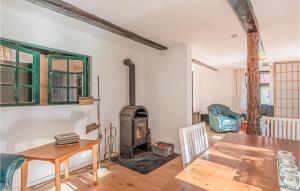 a living room with a wood stove and a table at Lovely Home In Sderheistedt With Kitchen in Süderheistedt