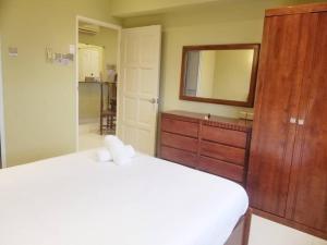 a bedroom with a bed and a mirror and a sink at VIP Suite Seaview Batu Ferringhi 1003-2 Bedroom in Batu Ferringhi