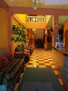 a living room with a checkered floor at Hostal Olas Del Titicaca in Copacabana