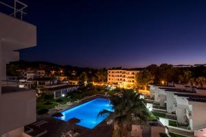 a view of a pool at night at Camelina Suites in San Antonio Bay