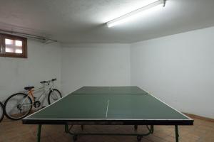 a ping pong table in a room with a bike at The Yellow House - Solarium - Climatized Pool in Gáldar