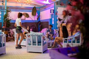 a group of people in a room with beds at Camelina Suites in San Antonio Bay +37 photos
