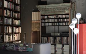 a living room with several shelves of dvds at B&B Design in Bologna