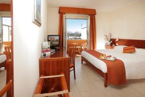 Postel nebo postele na pokoji v ubytování Hotel Michelangelo