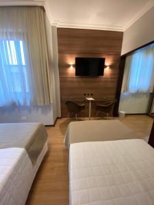 Postel nebo postele na pokoji v ubytování Curitiba Palace Hotel